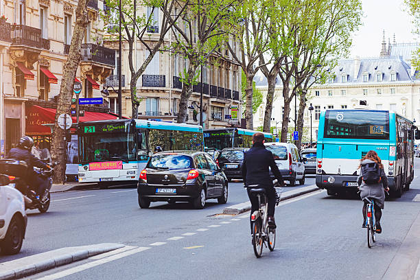 Paris, France - April 28, 2016:  Cyclist, cars and  big bus on the one way street Boulevard Saint-Michel
