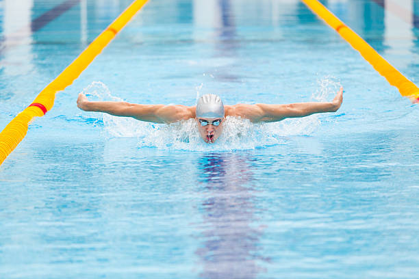 istock dynamic and fit swimmer in cap breathing performing the butterfly 539816500