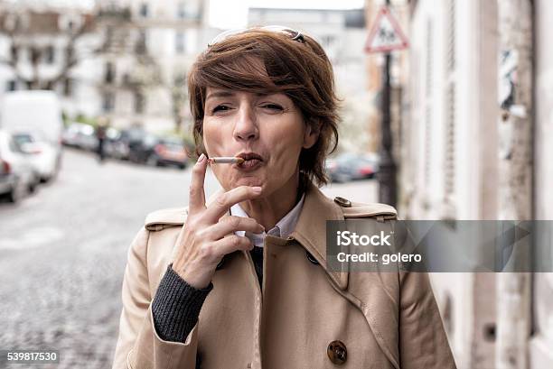 Elegant Parisian Woman Smoking At Street Stock Photo - Download Image Now - Cigarette, Smoking - Activity, One Woman Only