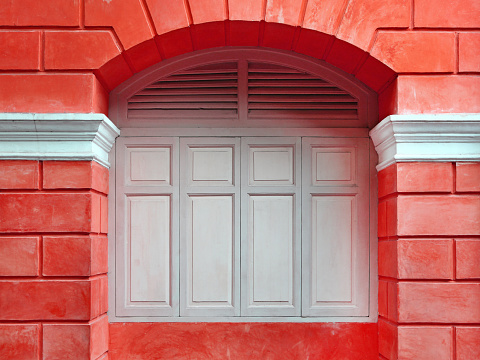 Red wall with close windows, Europe style