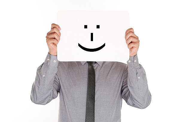 istock Man Holding Paper With Smiley Face In Front Of Head 539820532