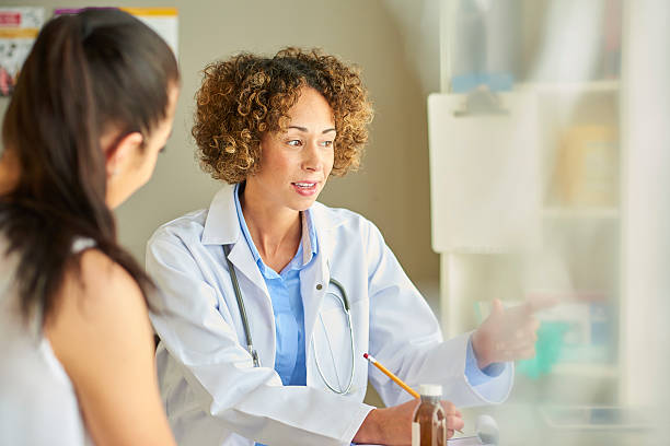 istock female doctor at desk with patient 539821564