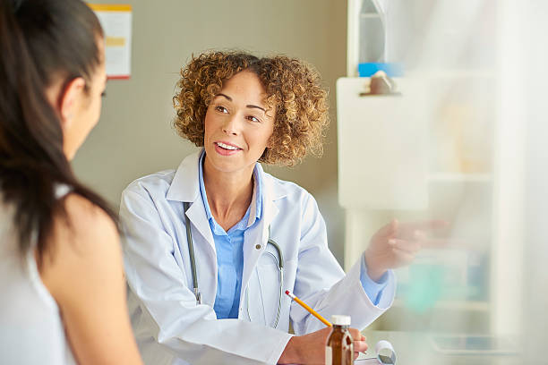 istock female doctor at desk with patient 539821668
