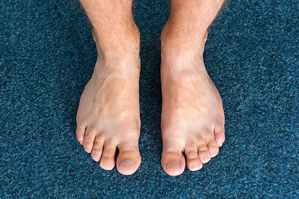 Healthy male feet feeling comfortable at home stock photo