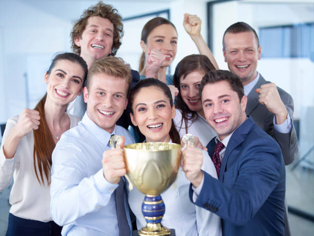 istock Successful businesspeople celebrating with the cup in hands 539822920
