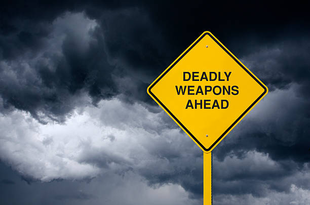 istock Road Sign, Deadly Weapons in Front of Storm Clouds 539823022