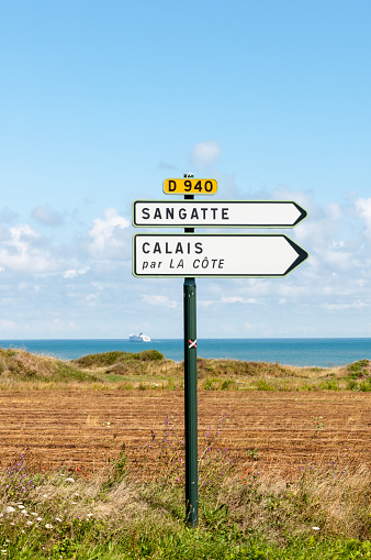 Sangatte and Calais direction sign by the side of the road