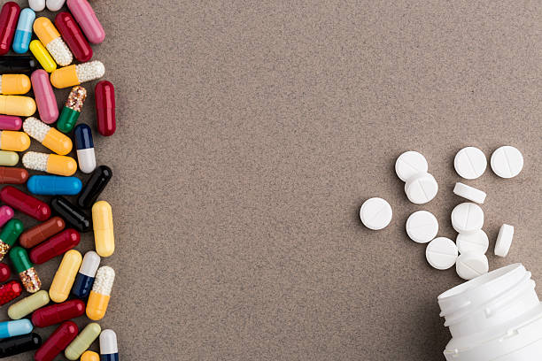 istock Various colorful capsules and pill bottle from white round pills 539823180