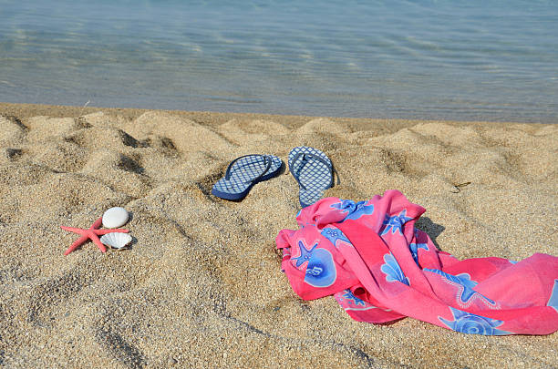 istock Blue Flip Flops and Pareo Scarf on Beach 539824110