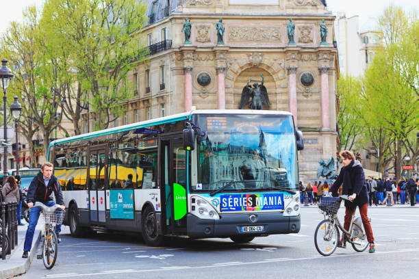 Paris, France - April 28, 2016:  Cyclist, cars and  big bus on the one way street Boulevard Saint-Michel
