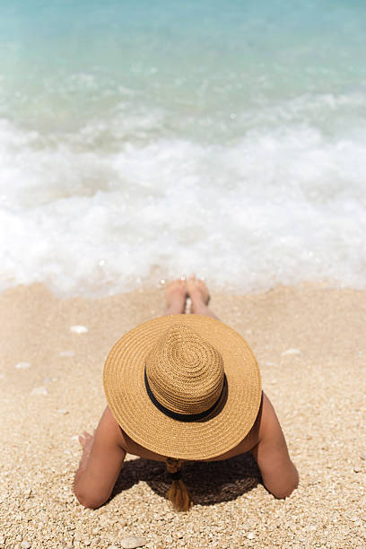 istock woman in summer hat on beach 539825850