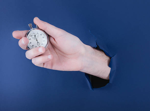 istock Male hand breaking through the blue paper background 539825868