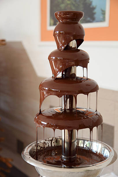 istock Chocolate fondue fountain with marshmallow being dipped. 539826414