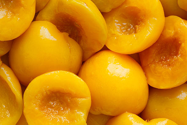 istock Background of canned peach halves from above. 539827406