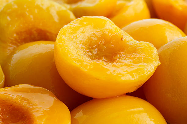 istock Background of canned peach halves in perspective. 539827488