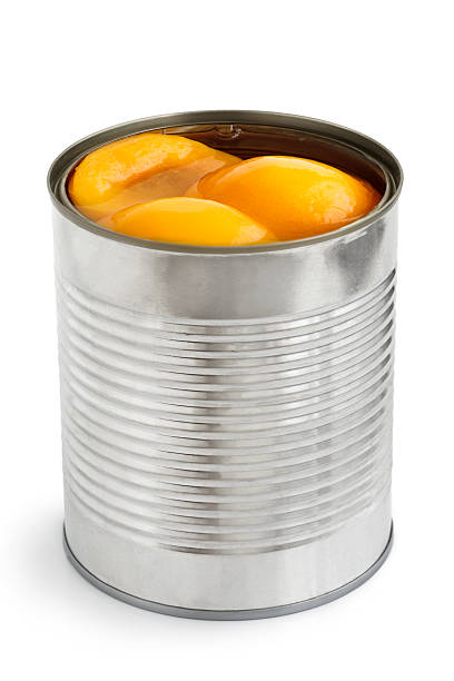 istock Open can of peach halves in syrup in perspective. 539828092