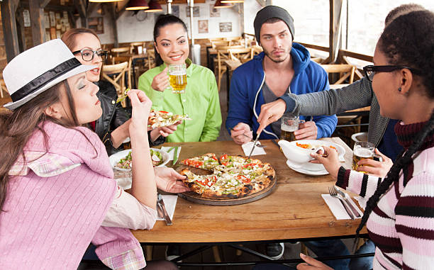 istock Group of young people dining and having fun in restaurant 539828652
