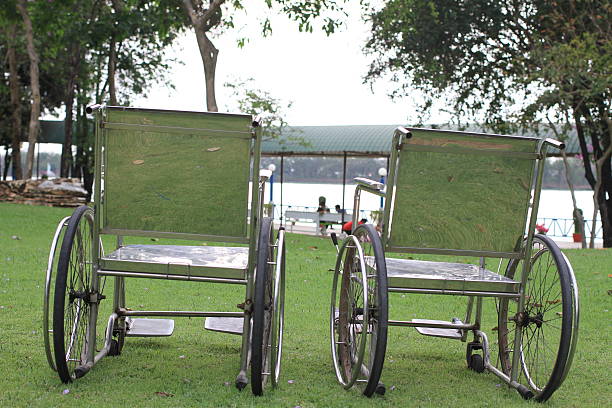 istock two wheelchairs  in the park against the river background 539829940