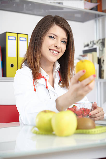 istock young nutritionist showing lemon 539832102