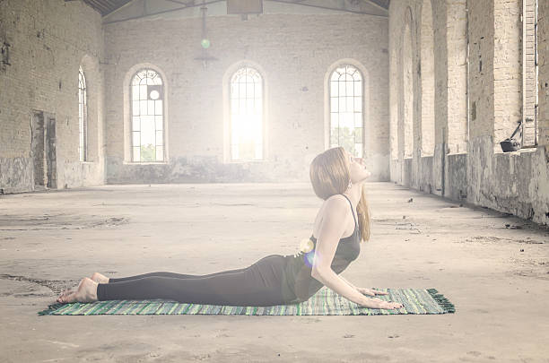 redhead girl with black make-up exercise yoga positions