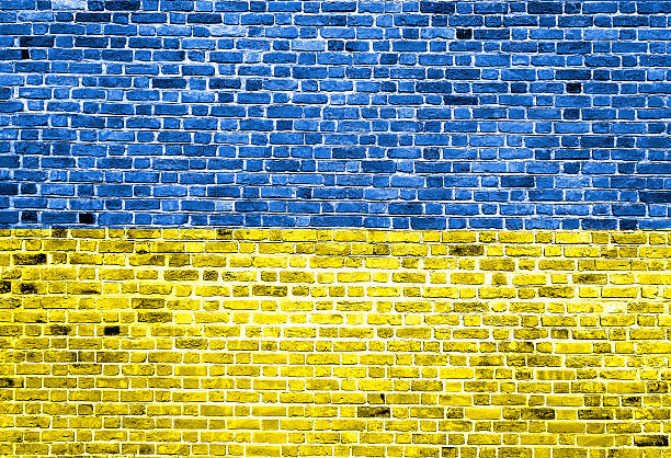 istock Flag of Ukraine painted on brick wall, background texture 539832314