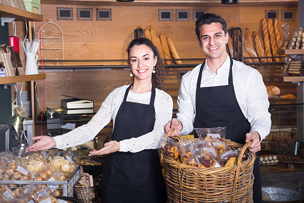 istock Man and woman bakers in bakery 539832368