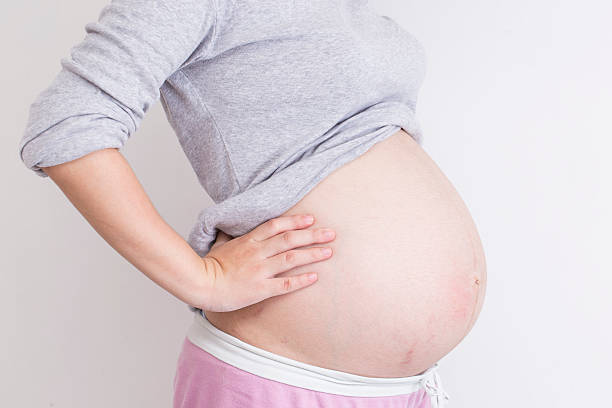 istock Pregnant woman has backache and touching her torso 539834732