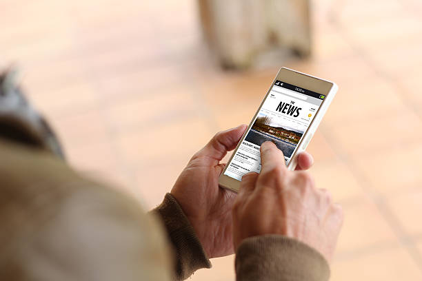 istock Brown young man news smartphone 539838434