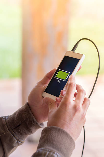 istock hands holding smartphone with full battery on screen 539838764