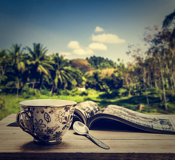istock Coffee cup with magazine on wooden table 539838868