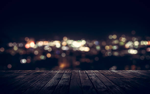 istock Wooden plank above the town at night 539839486