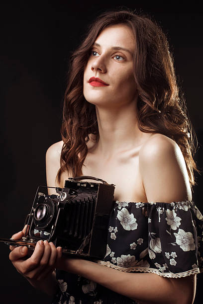 istock Pretty woman photographer with retro camera 539839540