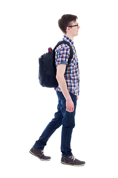 istock handsome teenage boy with backpack walking isolated on white 539839970