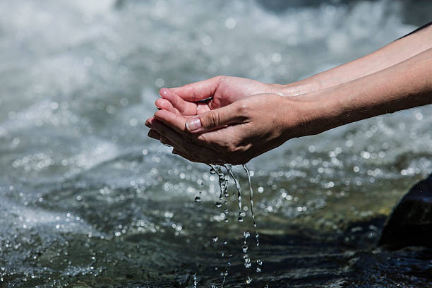 istock Hands sachibalaya clean water from the mountain bubbling 539840342