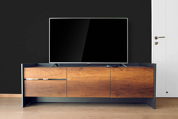 istock Led TV on TV stand with black wall 539840486