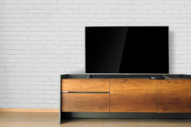istock Led TV on TV stand with white brick wall 539840608