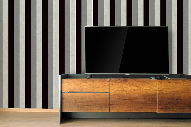 istock Led TV on TV stand with black & white wallpaper 539840776