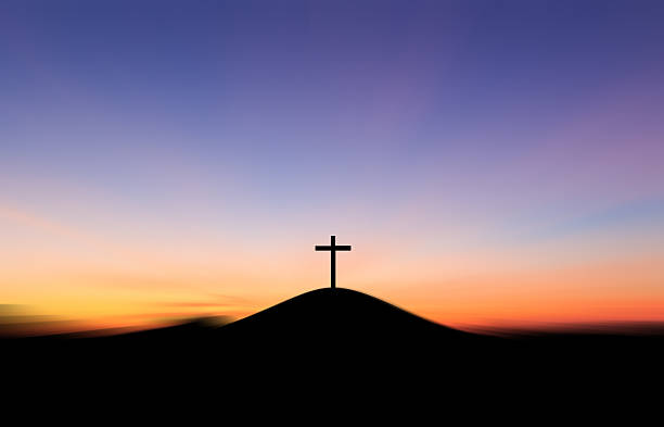 istock Cross on the hill behind the blur sunset. 539840792