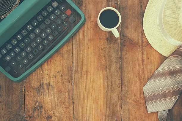 typewriter next to cup of coffee and man accessories