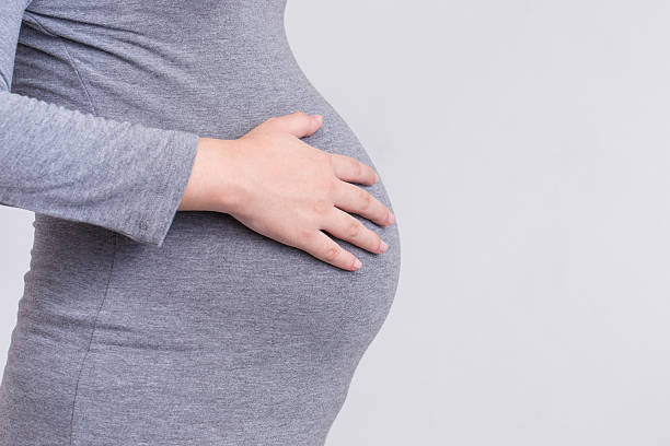 istock Pregnant woman touching her belly 539842148