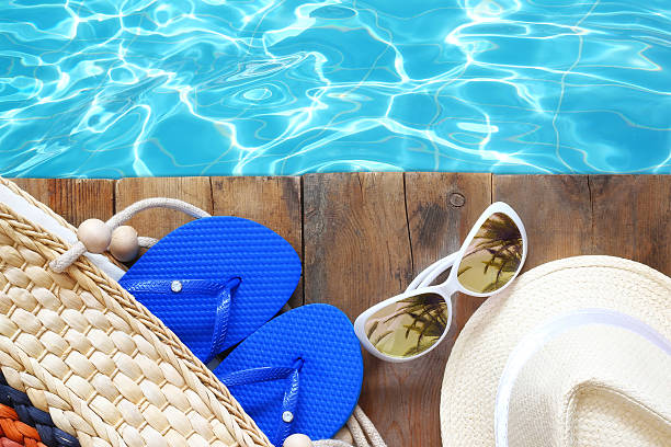 istock swimming pool and wooden deck with beach accessories 539844040