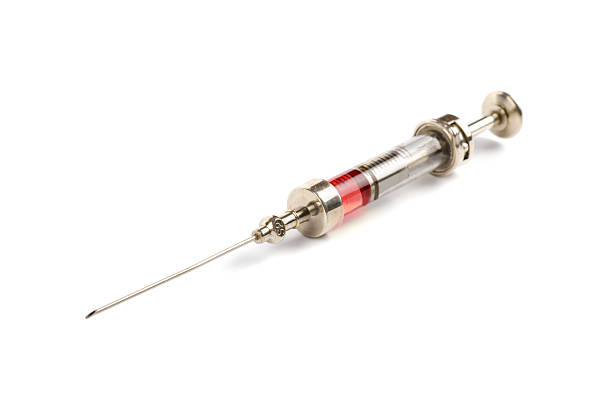 istock historic glass syringe with red fluid 539844340
