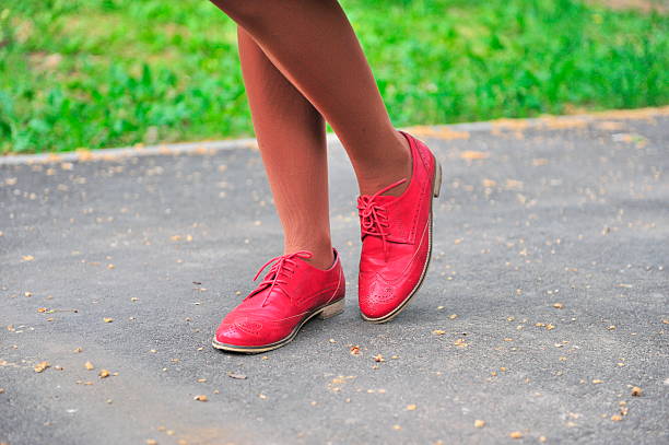 Woman's legs in the red shoes