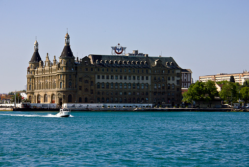 Istanbul, Turkey - May 8, 2016: Haydarpasha Station and passenger ship on the bosphorus. Haydarpasha is a major intercity rail station and transportation hub in İstanbul. It is the busiest rail terminal in Turkey and the Middle East and one of the busiest in Eastern Europe. The terminal also has connections to İETT bus and ferry service.