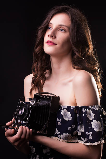 istock Beautiful brunette woman with retro camera 539846804