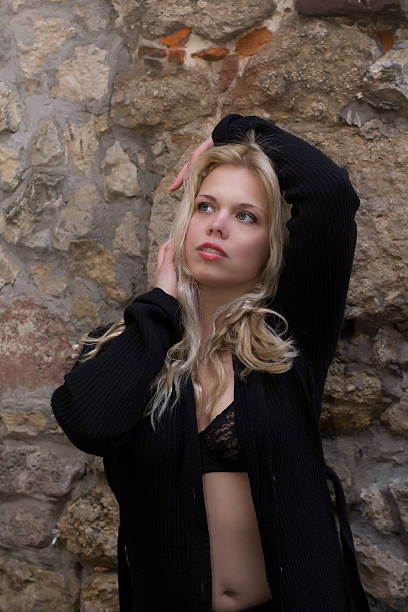 istock Blonde model in unbuttoned shirt near the wall 539846982