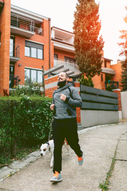 istock Man Jogging With His Dog. 539847160