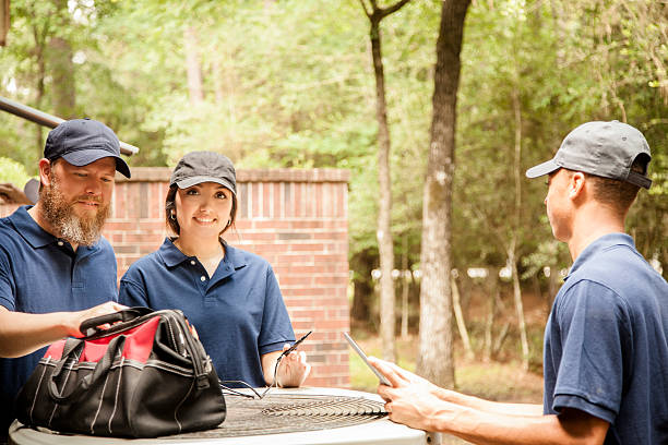 istock Air conditioner repairmen work on home unit. Blue collar workers. 539850176