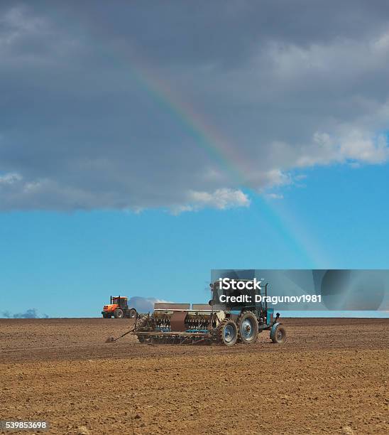 Tractors In The Field Stock Photo - Download Image Now - Rainbow, Tractor, Agricultural Field