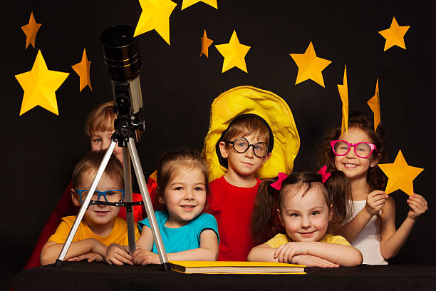 istock Children studying astronomy with telescope 539854784